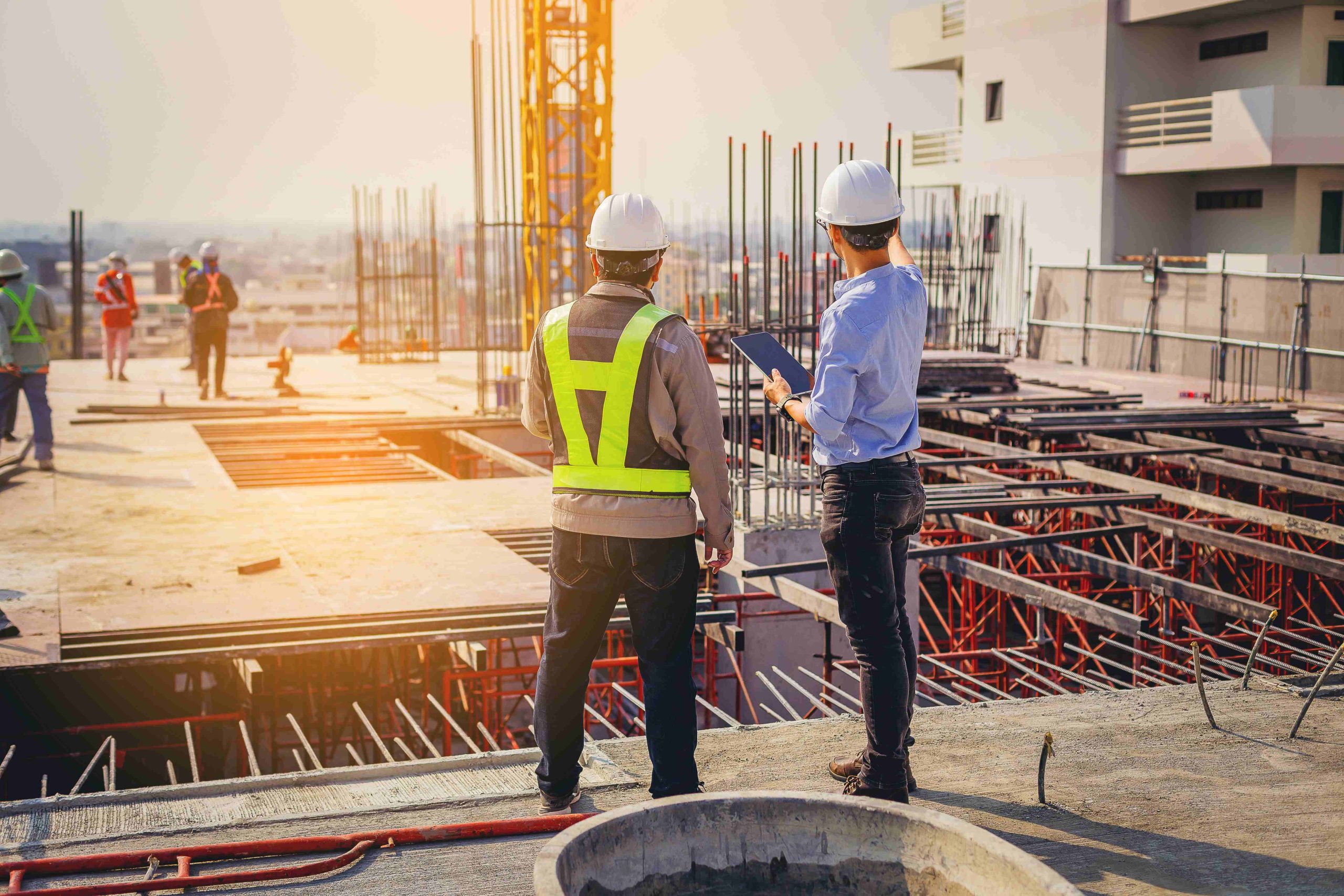 Two engineers reviewing the business structure on a building construction project